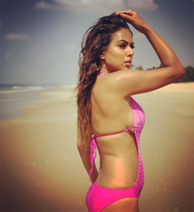 Nia Sharma looks smoking hot in a pink monokini as she soaks in 'vitamin sea' : Bollywood News - Bollywood Hungama