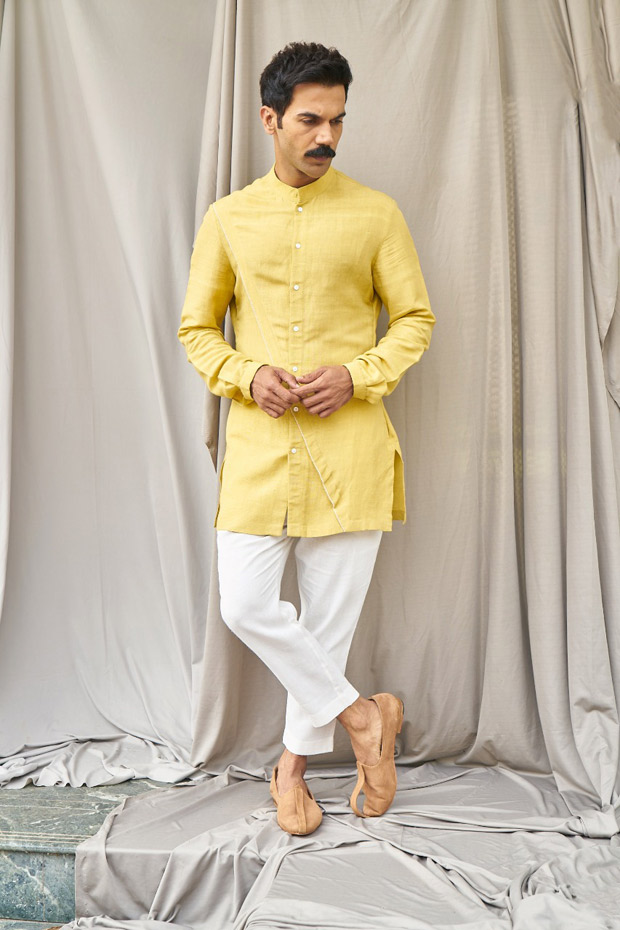 Premium Photo | A model wears a white shirt with yellow pants and a yellow  shirt with a bow on the front