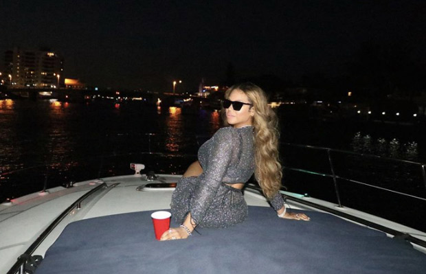 Beyoncé stuns in silver sheer wrap top and matching slit skirt she heads to Miami