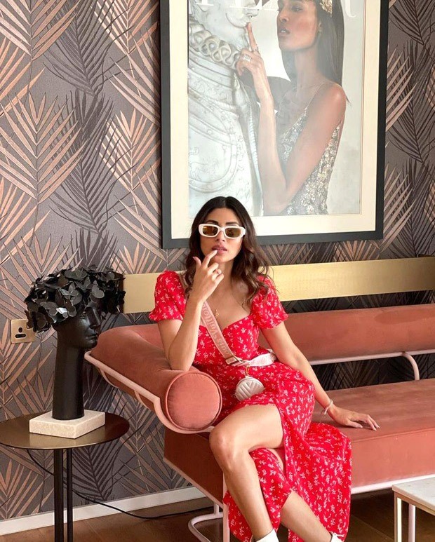 Mouni Roy pairs a red thigh-high slit midi dress with Louis Vuitton mini cross body bag worth Rs. 2.37 lakh