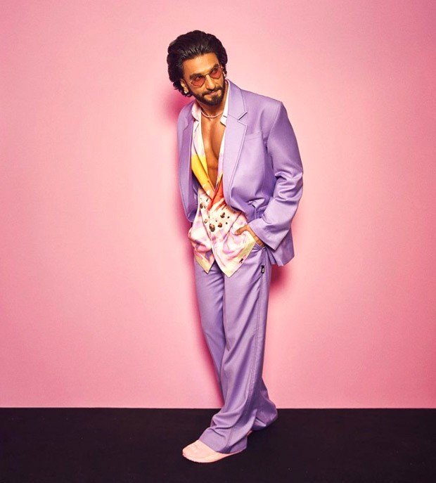 Ranbir in a gold jacket and Ranveer in a hot pink suit at an event