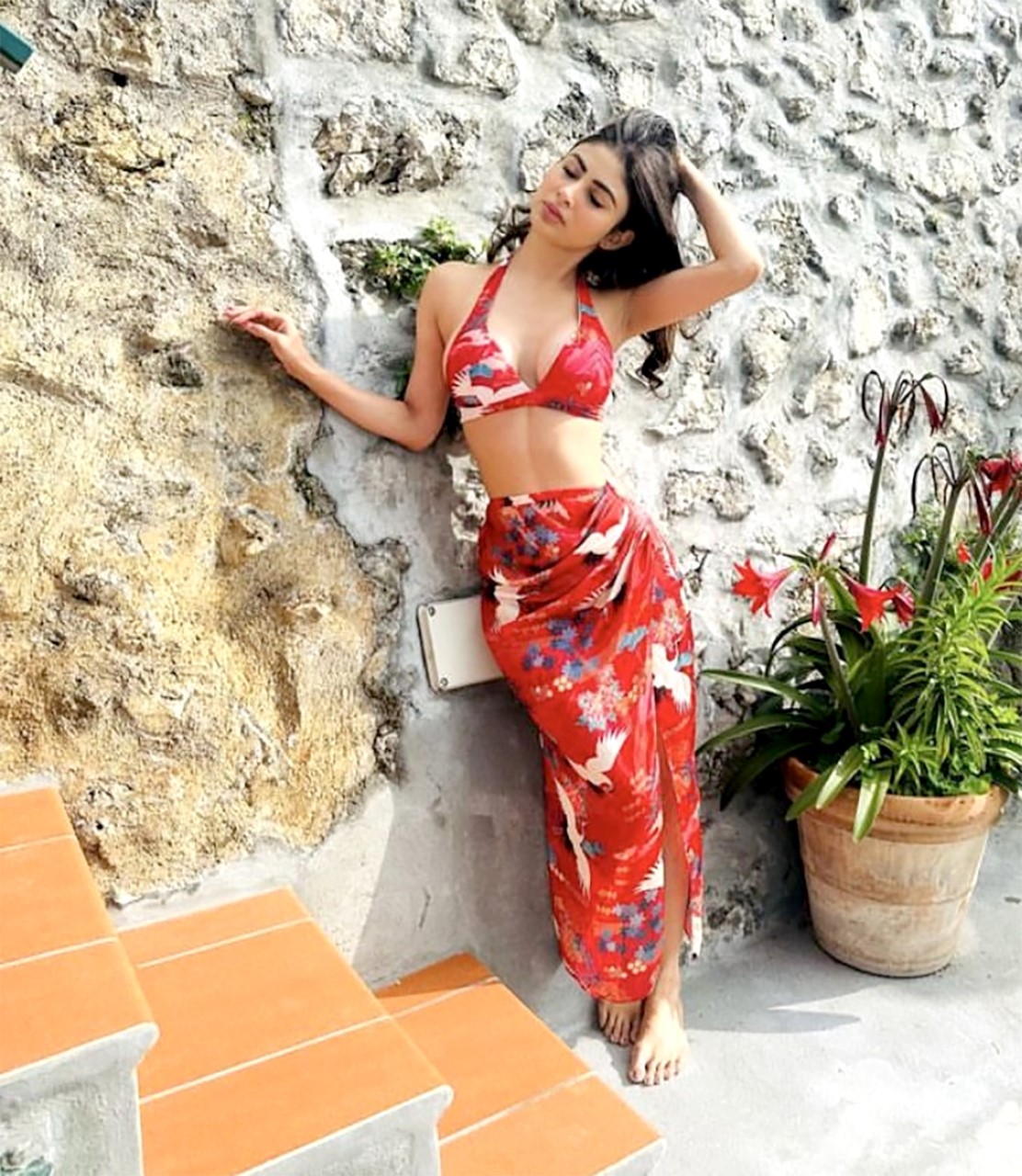 Mouni Roy blooms in her mesmerizing red sarong and bikini, adding